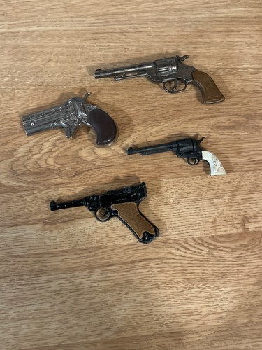 Four miniature metal - metal, pistols